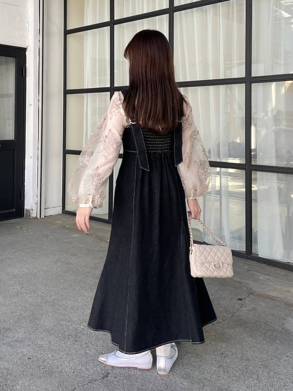 ホワイト系のシャツ/ブラウス、ホワイト系のショルダーバッグ、ブラック系のデニムジャケットを着用したレディースの冬コーディネートの6枚目の写真