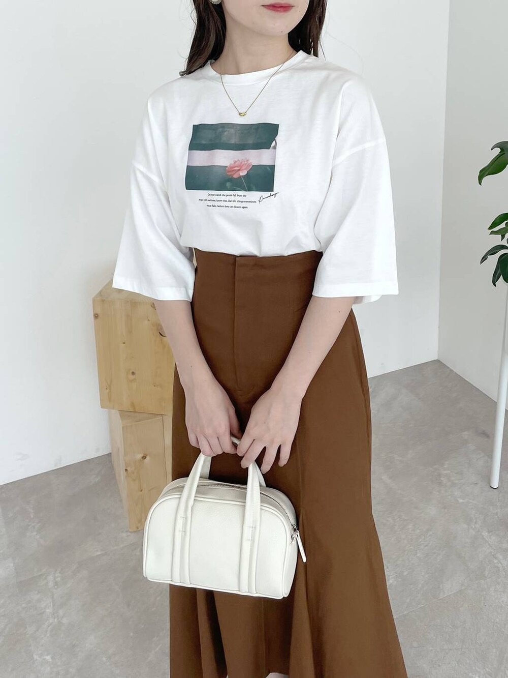 ブラウン系のサンダル、ホワイト系のTシャツ/カットソー、ホワイト系のボストンバッグを着用したレディースの夏コーディネートの4枚目の写真