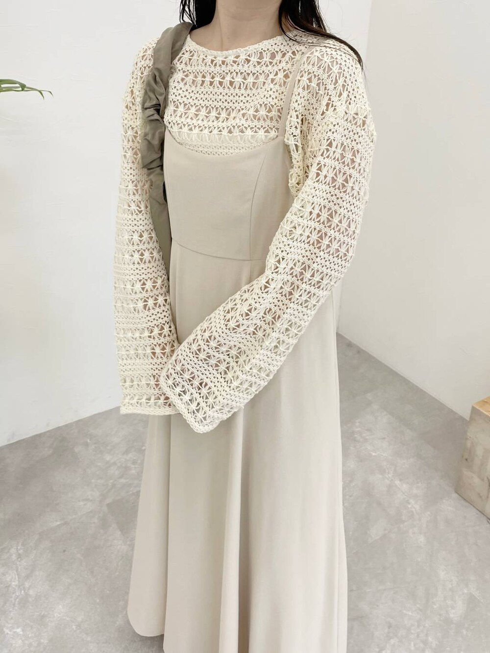 ホワイト系のワンピース、ホワイト系のカーディガン/ボレロ、ホワイト系のサンダルを着用したレディースの春コーディネートの3枚目の写真