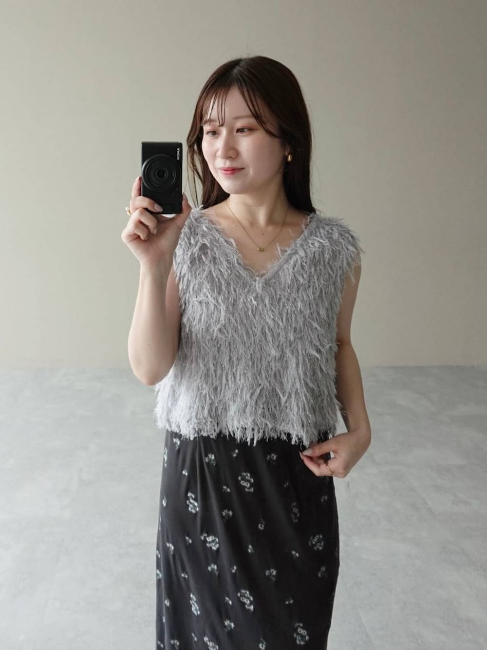 ブラック系のサンダル、グレー系のワンピース、グレー系のベストを着用したレディースの夏コーディネートの4枚目の写真