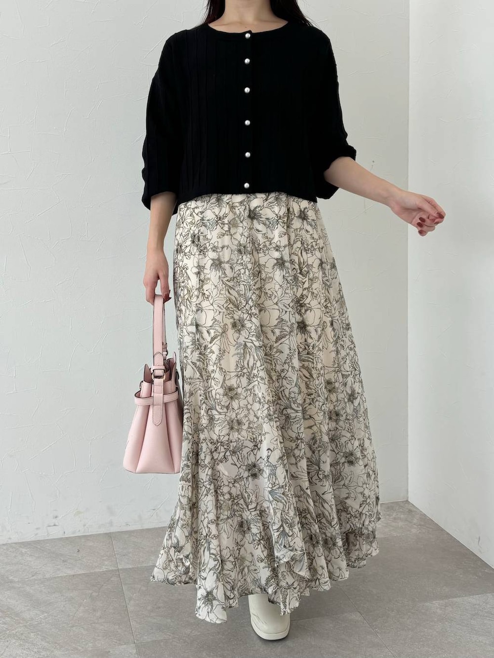 ベージュ系のピーコート、ピンク系のショルダーバッグ、ホワイト系のスカートを着用したレディースの秋コーディネートの7枚目の写真