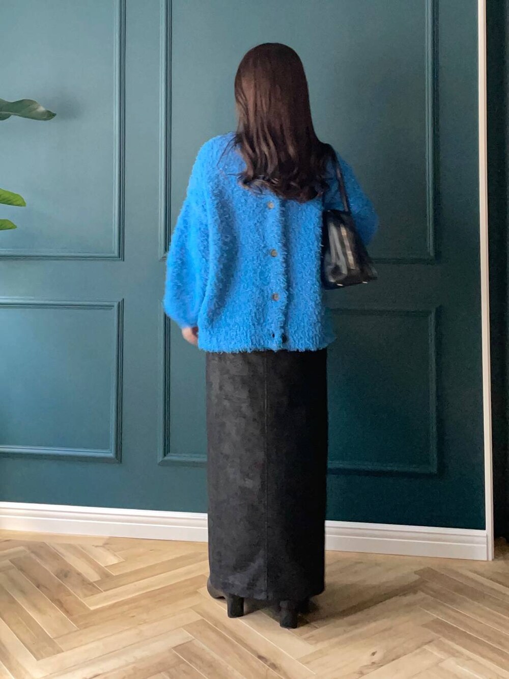 ブルー系のカーディガン/ボレロ、ブラック系のスカート、ブラック系のブーツを着用したレディースの秋コーディネートの2枚目の写真