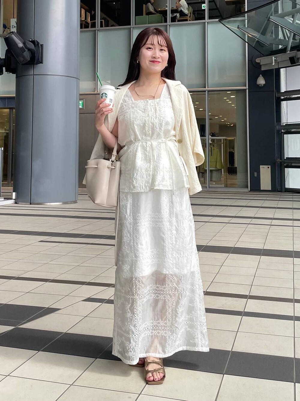 ブラウン系のサンダル、ホワイト系のテーラードジャケット、ホワイト系のシャツ/ブラウスを着用したレディースの夏コーディネートの2枚目の写真