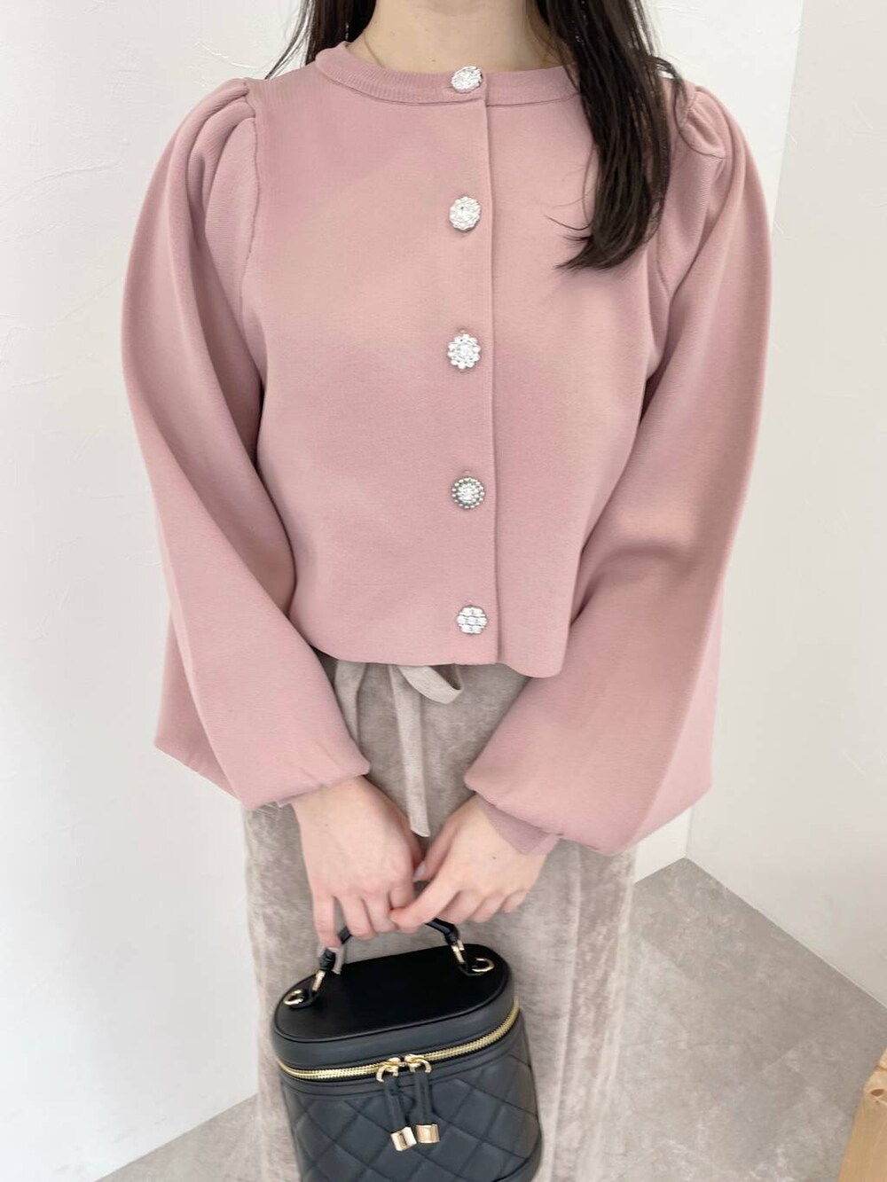 ブラウン系のスカート、ピンク系のカーディガン/ボレロ、グレー系のブーツを着用したレディースの冬コーディネートの3枚目の写真