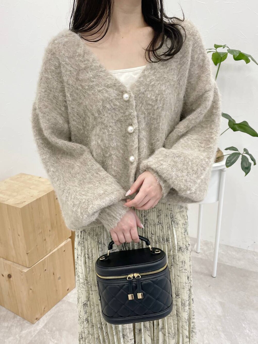 ホワイト系のタンクトップ、グレー系のブーツ、ブラウン系のカーディガン/ボレロを着用したレディースの冬コーディネートの3枚目の写真