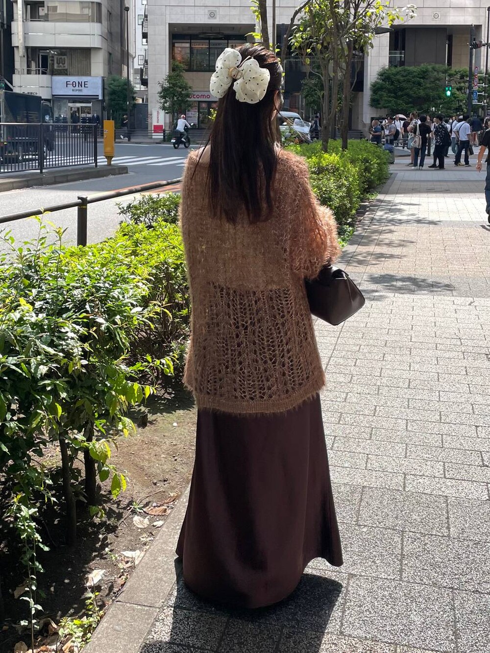 ブラウン系のスカート、ブラウン系のニット/セーターを着用したレディースの秋コーディネートの4枚目の写真