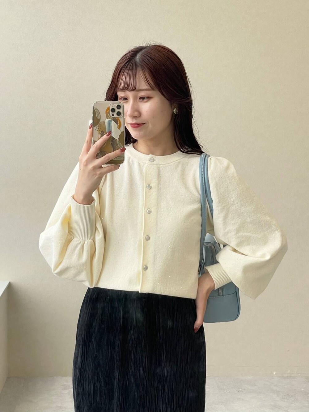 ホワイト系のブルゾン、ホワイト系のブーツ、ブラック系のスカートを着用したレディースの秋コーディネートの9枚目の写真