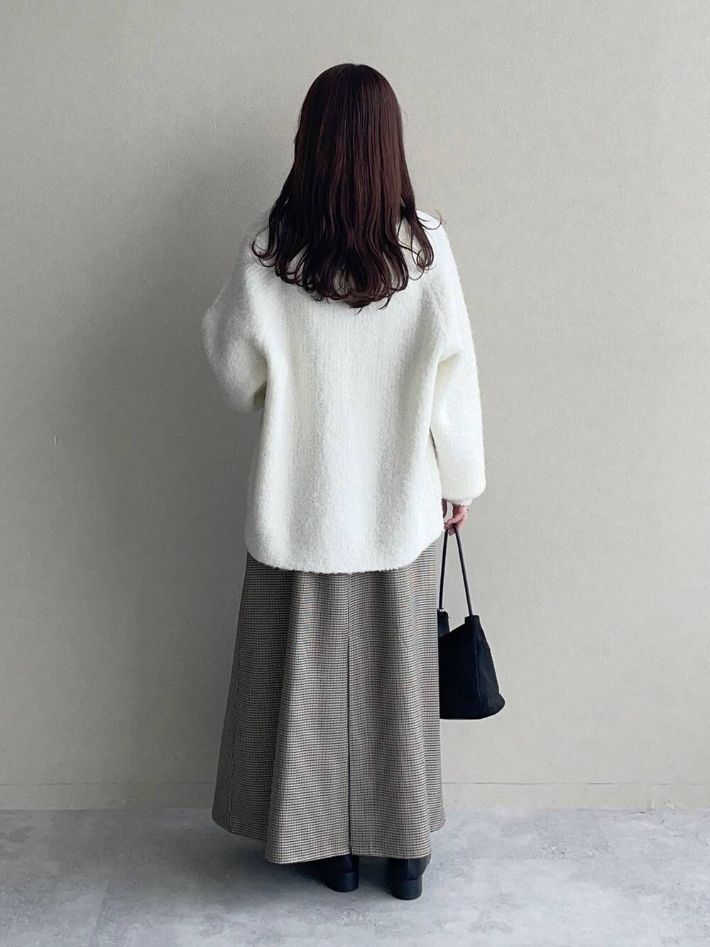 ホワイト系のカーディガン/ボレロ、ベージュ系のワンピース、ブラック系のTシャツ/カットソーを着用したレディースの秋コーディネートの2枚目の写真