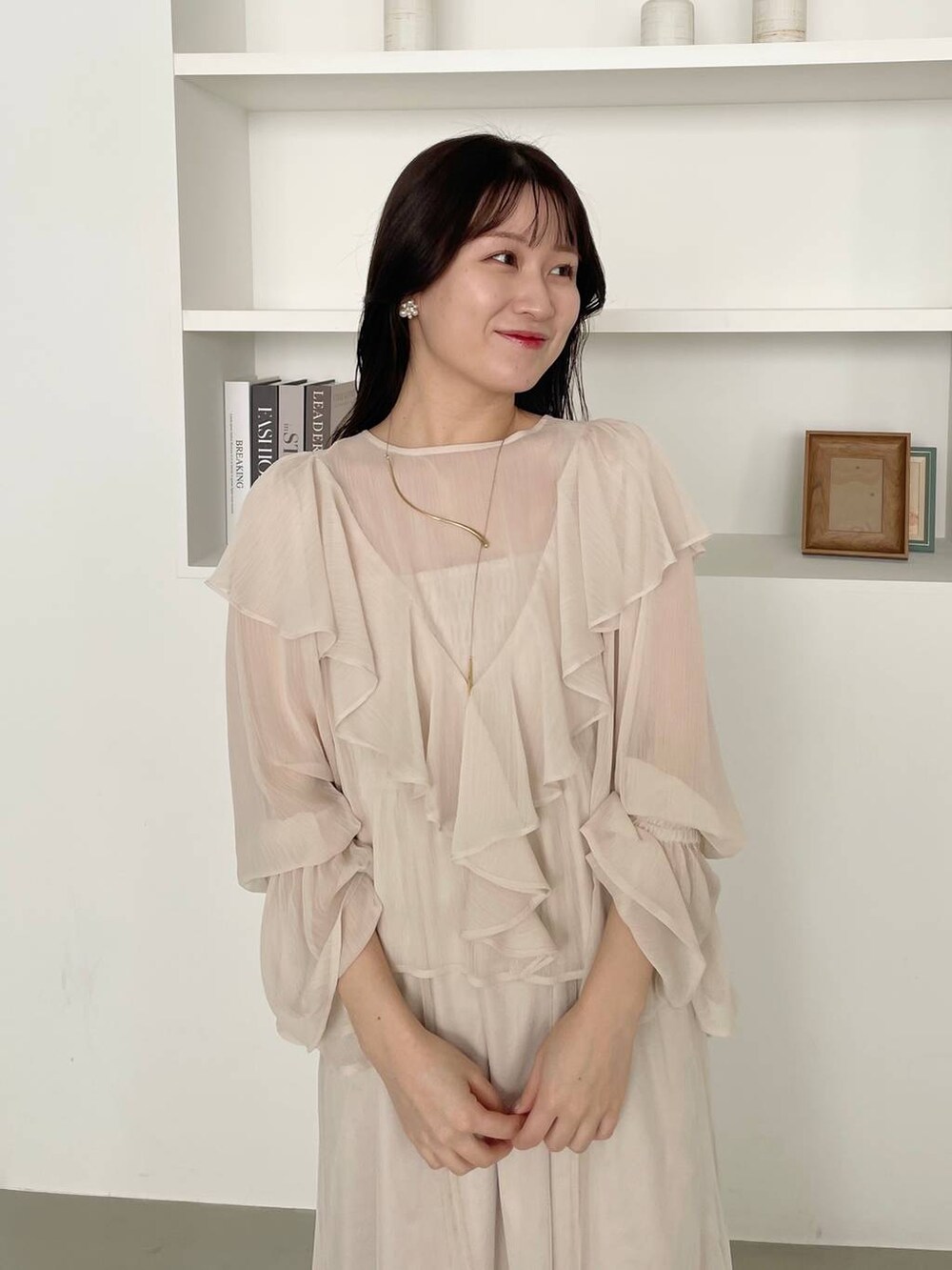 ベージュ系のショルダーバッグ、シルバー系のバレエシューズ、ホワイト系のワンピースを着用したレディースの春コーディネートの3枚目の写真