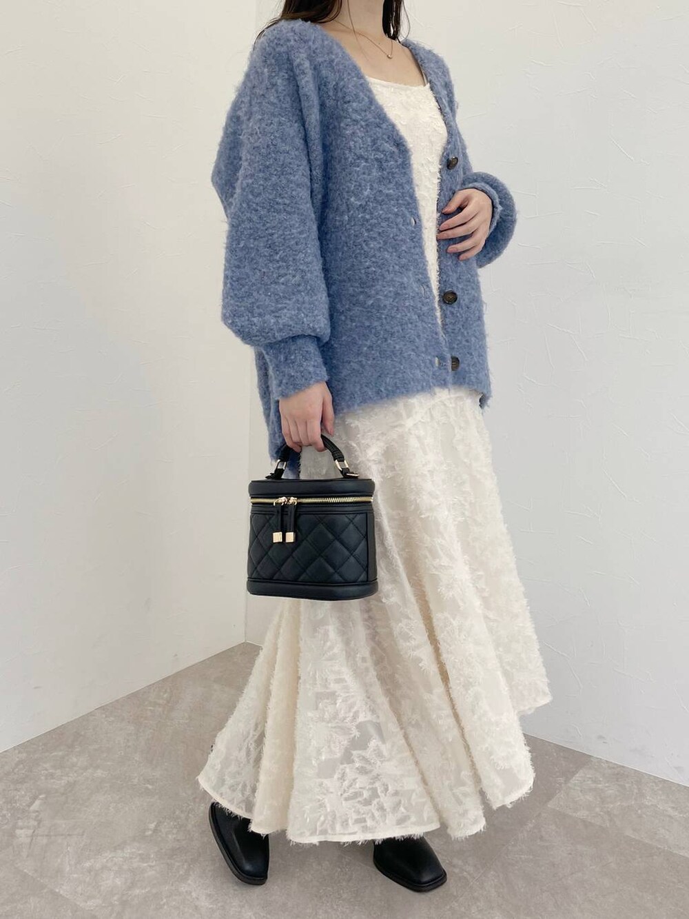 ブルー系のカーディガン/ボレロ、ブラック系のショルダーバッグ、ホワイト系のワンピースを着用したレディースの秋コーディネートの6枚目の写真