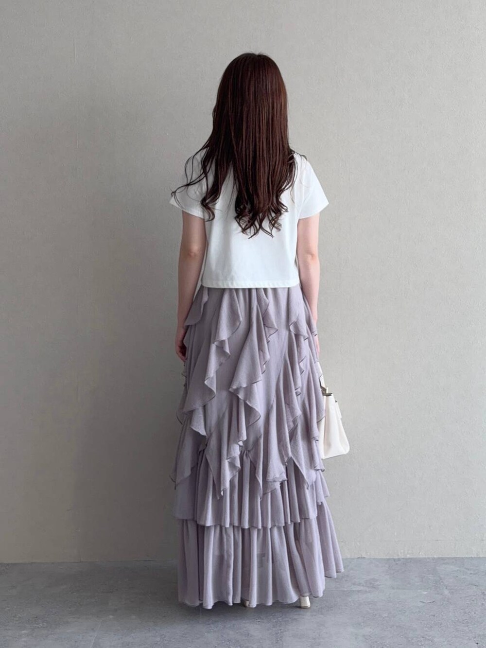 ホワイト系のTシャツ/カットソー、グレー系のスカート、ホワイト系のショルダーバッグを着用したレディースの秋コーディネートの2枚目の写真