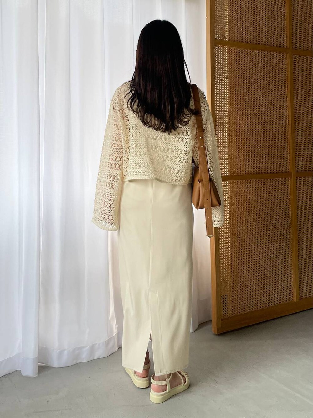 ホワイト系のドレス、ホワイト系のサンダル、ホワイト系のカーディガン/ボレロを着用したレディースの春コーディネートの2枚目の写真