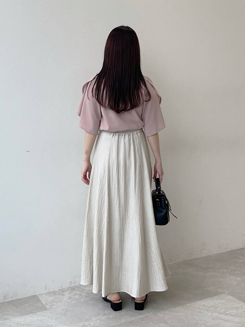 ブラック系のサンダル、ピンク系のTシャツ/カットソー、ブラック系のショルダーバッグを着用したレディースの春コーディネートの2枚目の写真