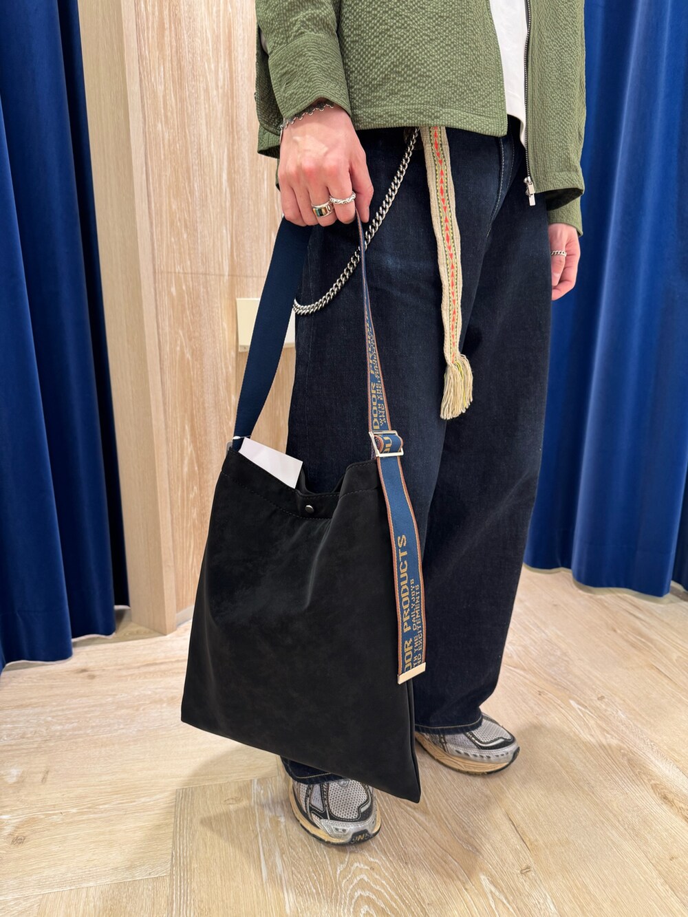 グリーン系のブルゾン、ブラック系のショルダーバッグを着用したメンズの冬コーディネートの3枚目の写真