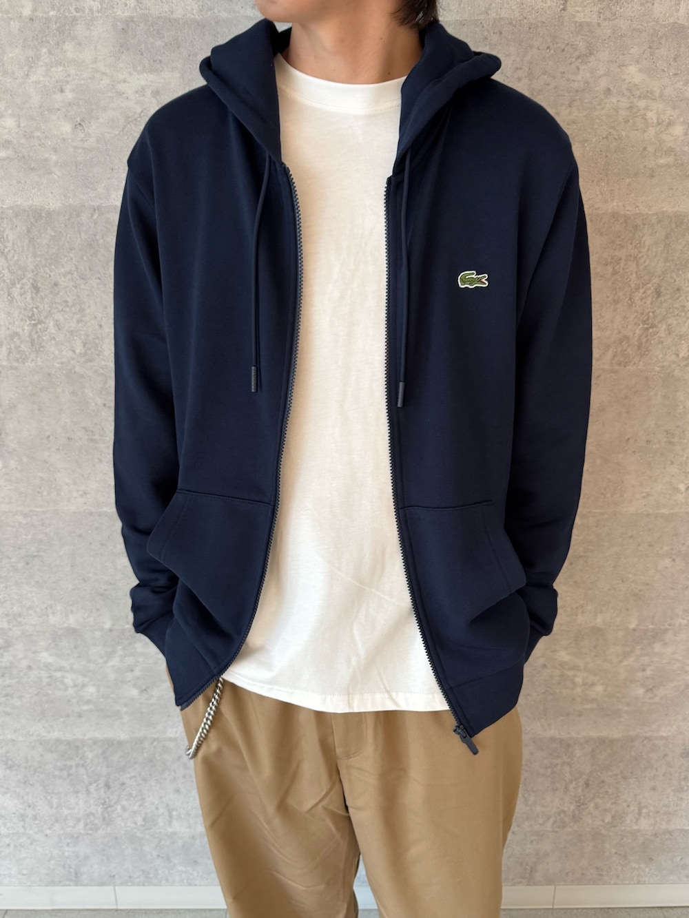 ブルー系のパーカー、ホワイト系のTシャツ/カットソー、ベージュ系のその他パンツを着用したメンズの秋コーディネートの2枚目の写真