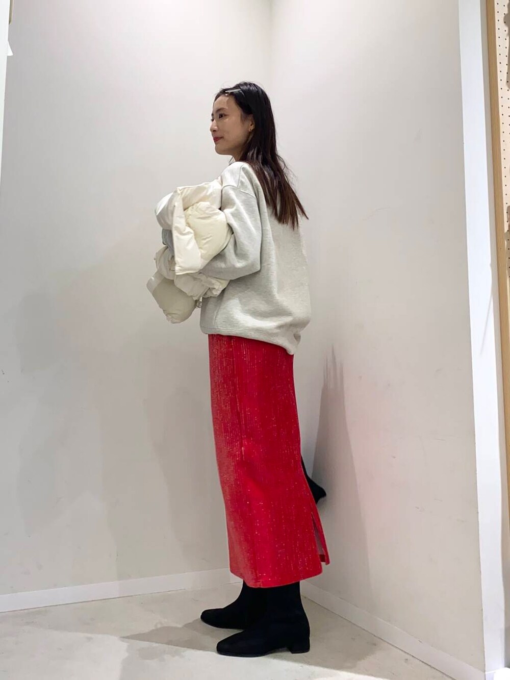 ブラック系のブーツ、ホワイト系のダウンベスト、その他のスウェットを着用したレディースの秋コーディネートの4枚目の写真