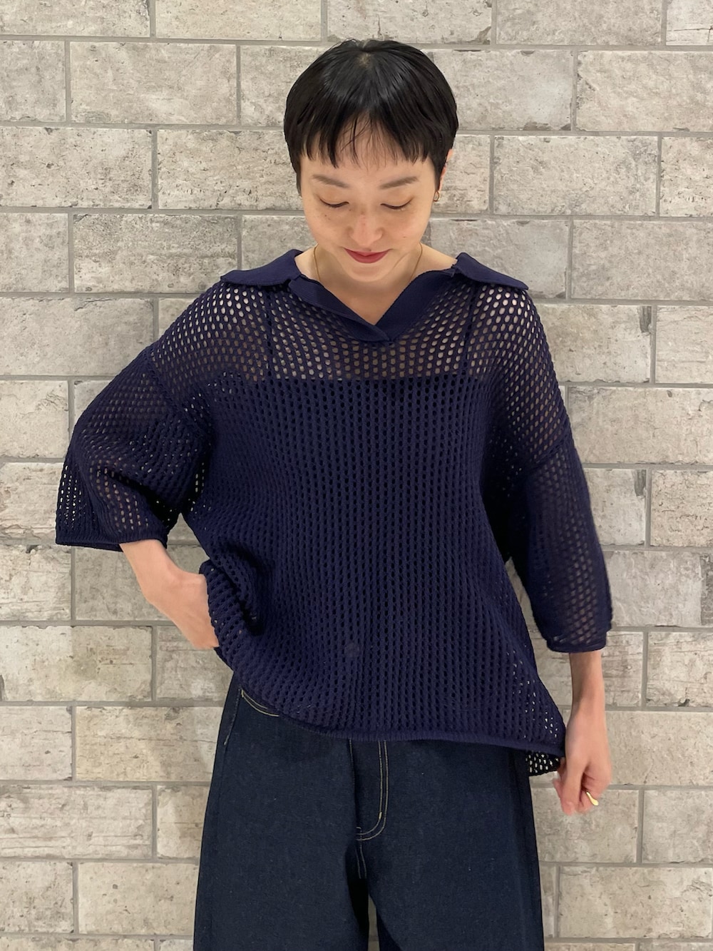 パープル系のニット/セーター、ブルー系のデニムパンツ、ブラウン系のサンダルを着用したレディースの春コーディネートの4枚目の写真