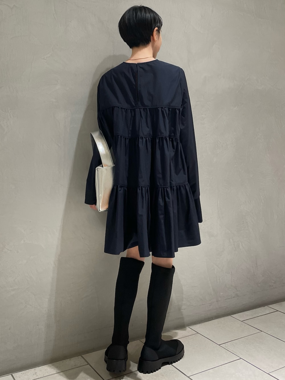 ブルー系のシャツ/ブラウス、ブラック系のブーツ、シルバー系のハンドバッグを着用したレディースの春コーディネートの3枚目の写真