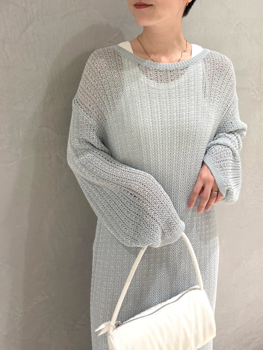 ブルー系のワンピース、ホワイト系のハンドバッグを着用したレディースの夏コーディネートの3枚目の写真