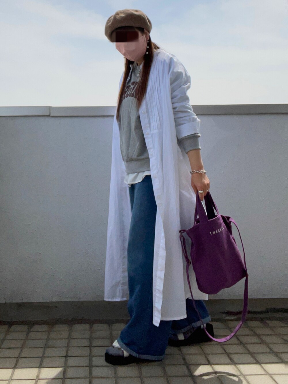 グレー系のスウェット、ホワイト系のワンピース、パープル系のトートバッグを着用したレディースの春コーディネートの3枚目の写真