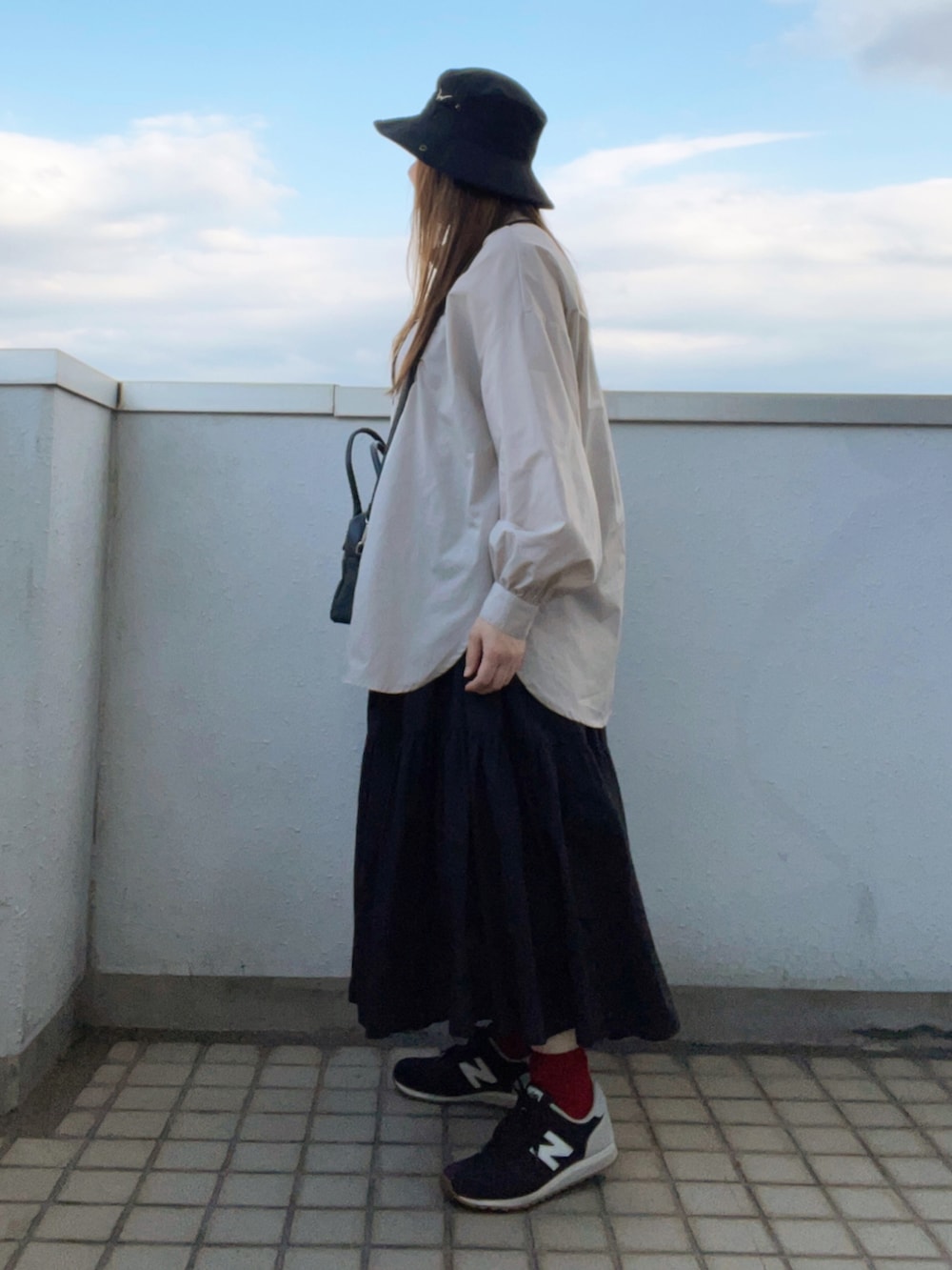 ベージュ系のシャツ/ブラウス、ブラック系のボストンバッグ、ブラック系のスカートを着用したレディースの夏コーディネートの3枚目の写真