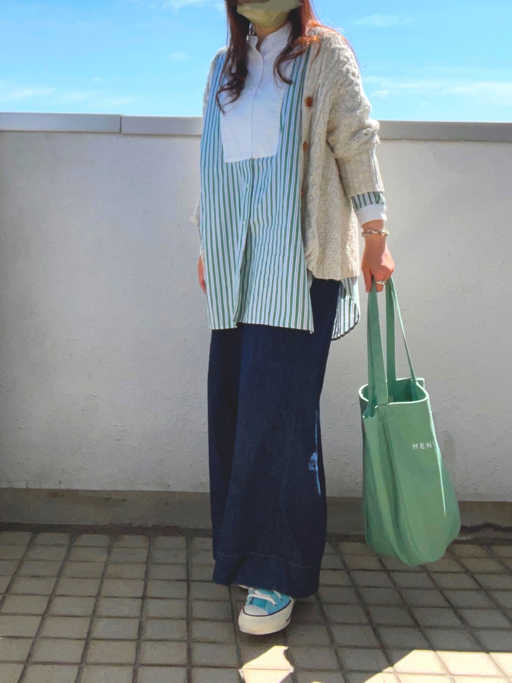 グリーン系のシャツ/ブラウス、グリーン系のトートバッグ、ブルー系のスニーカーを着用したレディースの春コーディネートの2枚目の写真