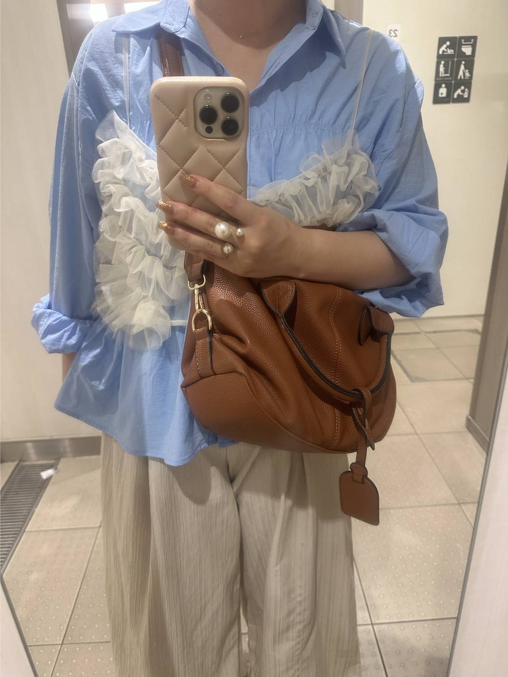 ブラウン系のボストンバッグ、ブルー系のシャツ/ブラウスを着用したレディースの秋コーディネートの4枚目の写真