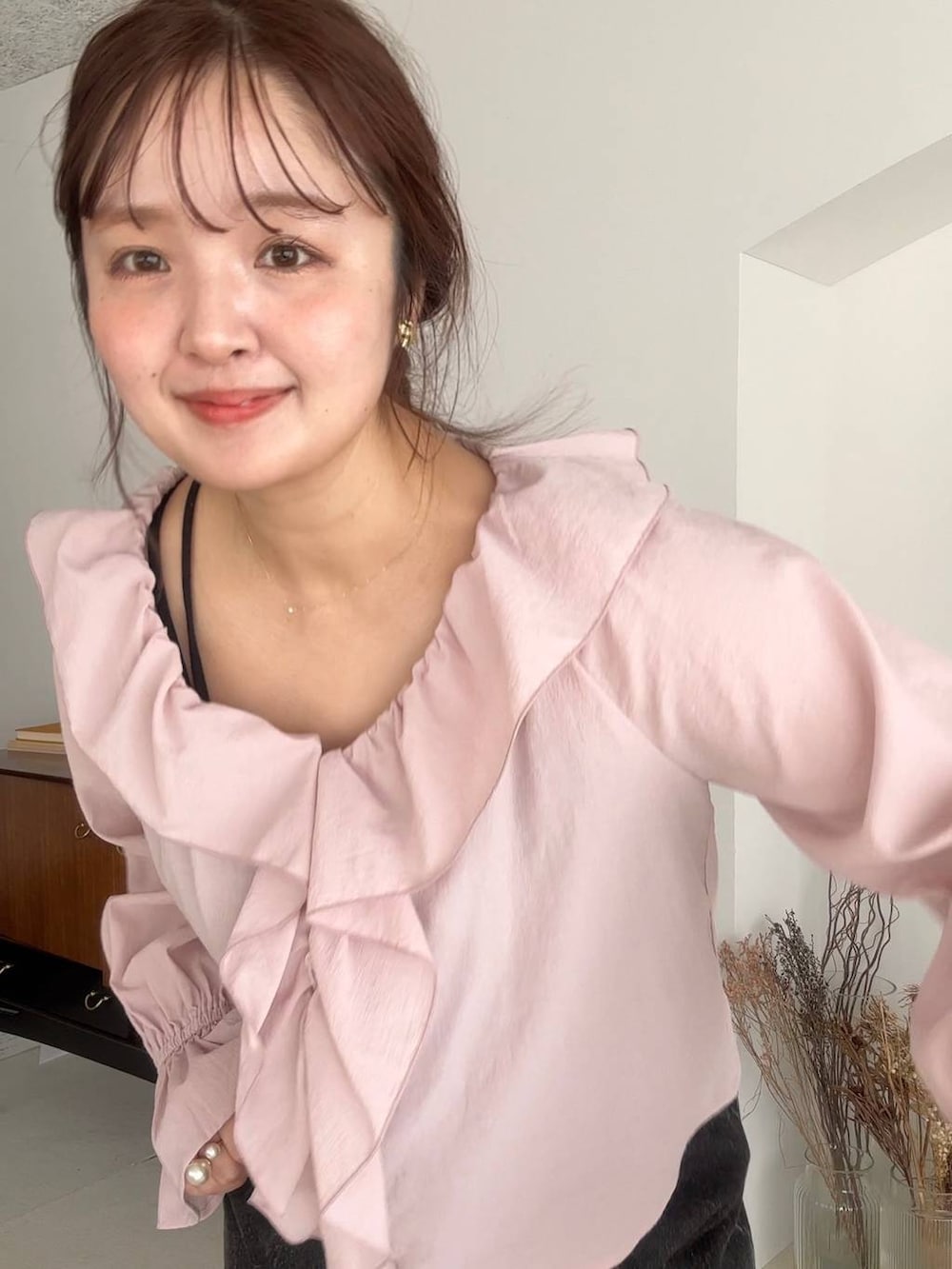 ブラック系のデニムパンツを着用したレディースの冬コーディネートの2枚目の写真