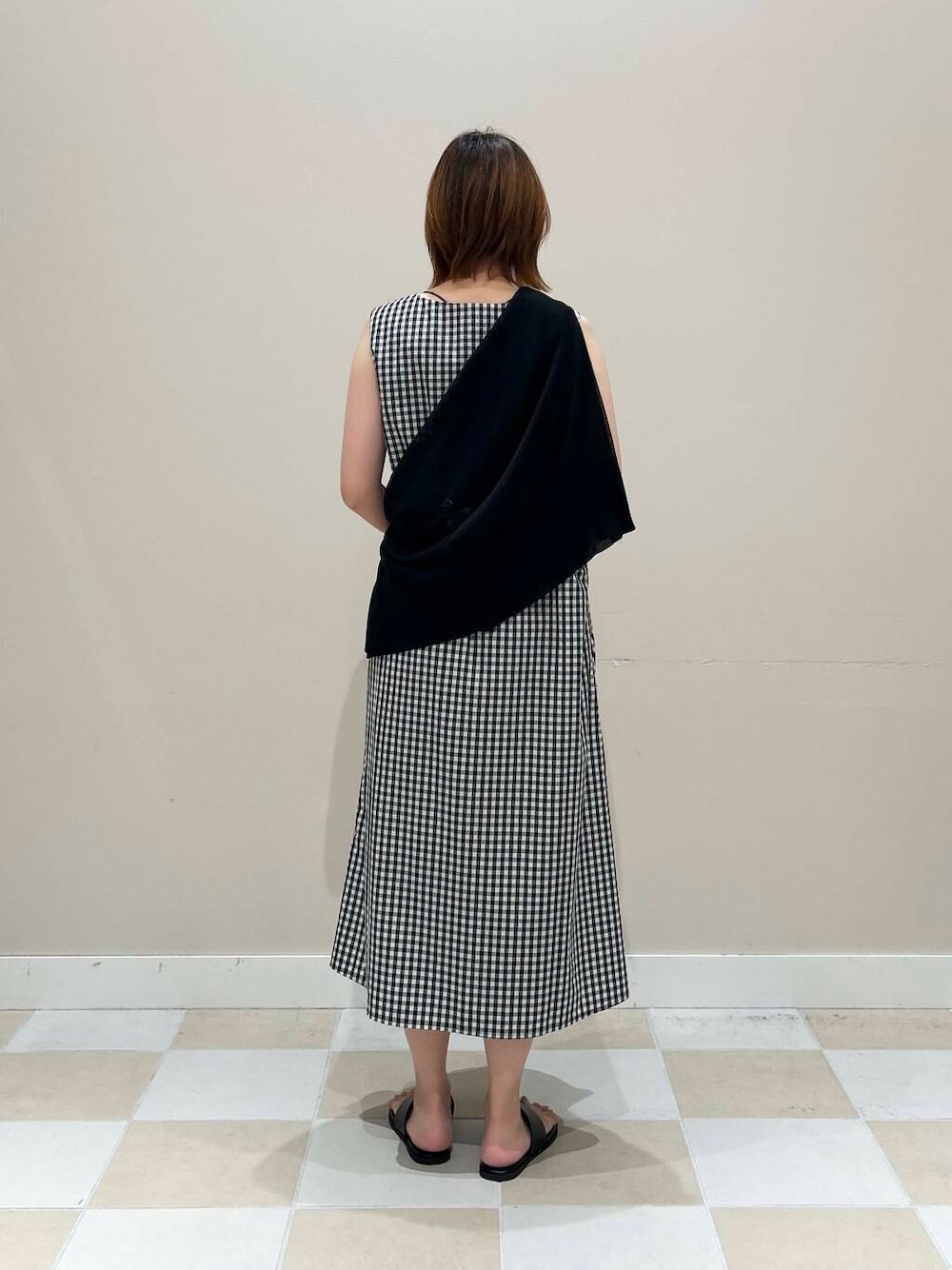 ベージュ系のトートバッグ、ブラック系のカーディガン/ボレロ、その他のワンピースを着用したレディースの夏コーディネートの3枚目の写真