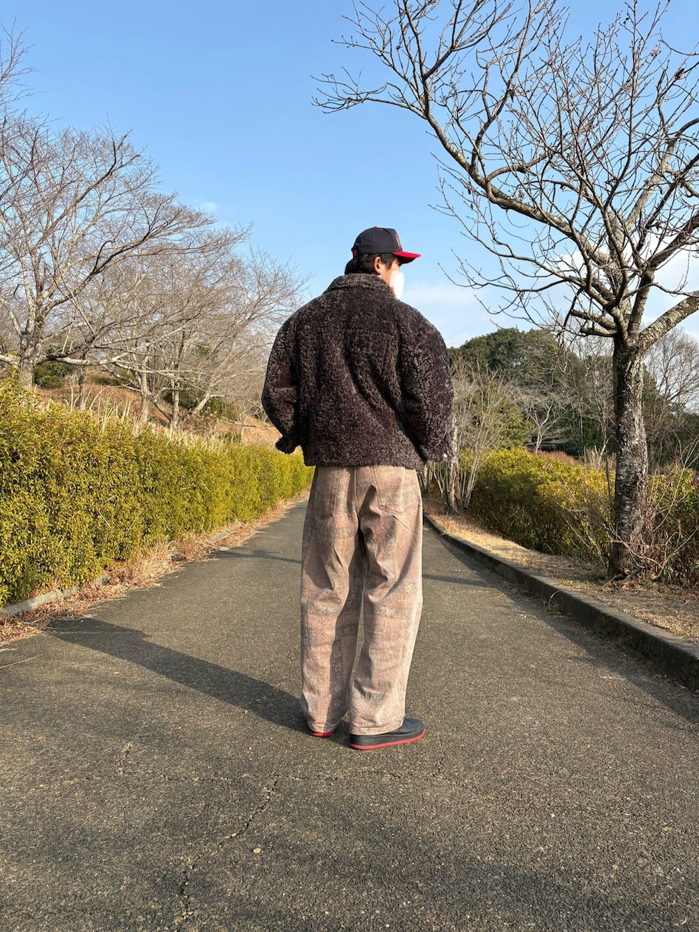 レッド系のスウェット、グレー系のブルゾン、その他のその他パンツを着用したメンズの冬コーディネートの3枚目の写真