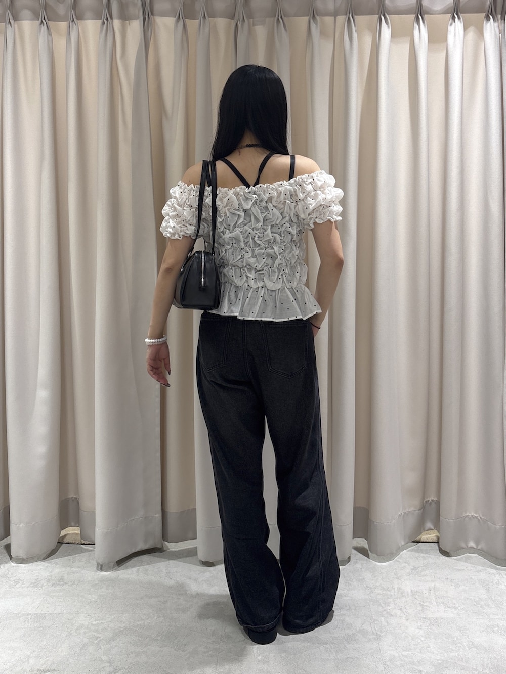 ブラック系のデニムパンツ、ホワイト系のシャツ/ブラウスを着用したレディースの秋コーディネートの3枚目の写真