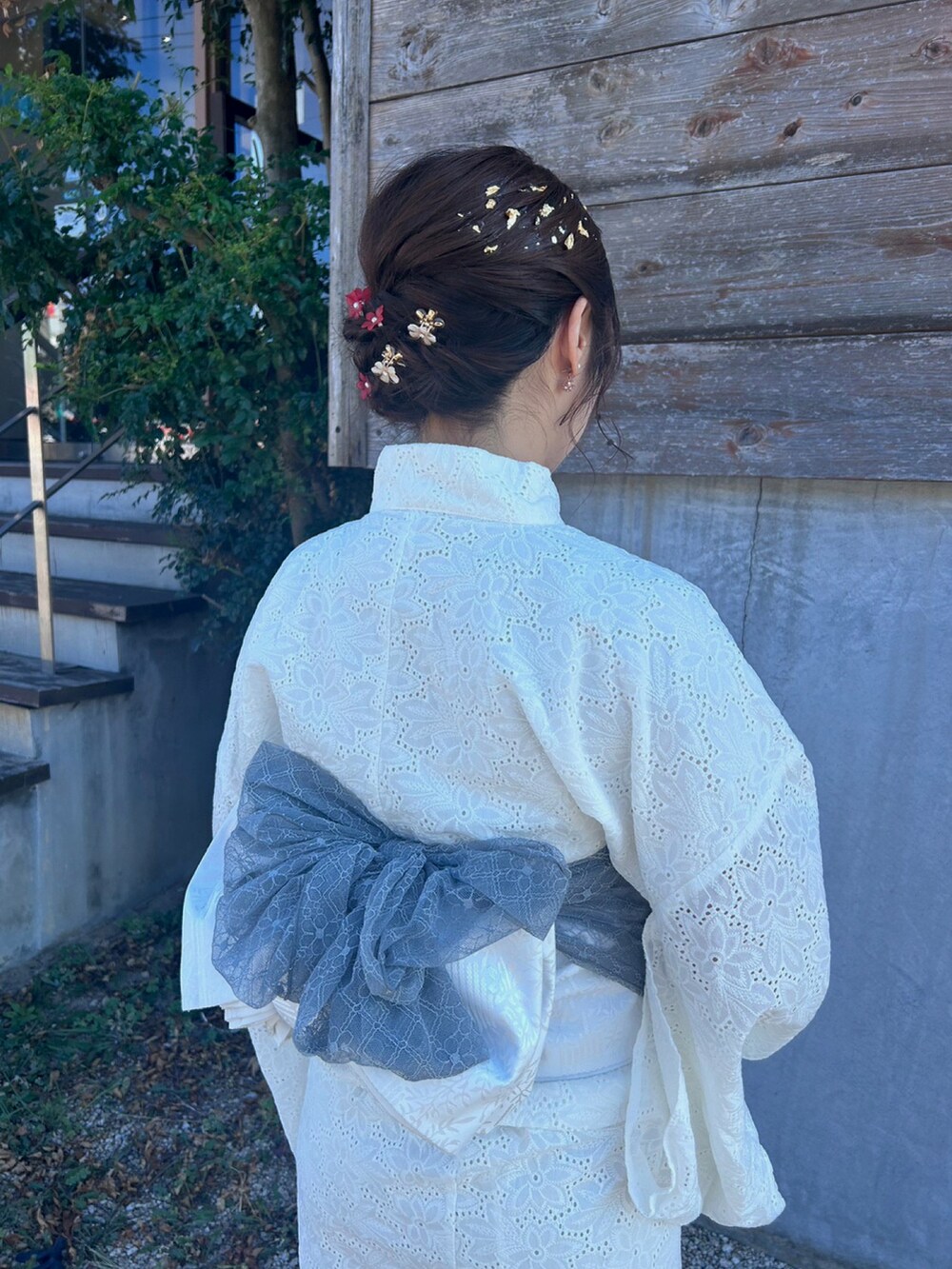 レッド系のヘアアクセサリーを着用したレディースの夏コーディネートの2枚目の写真