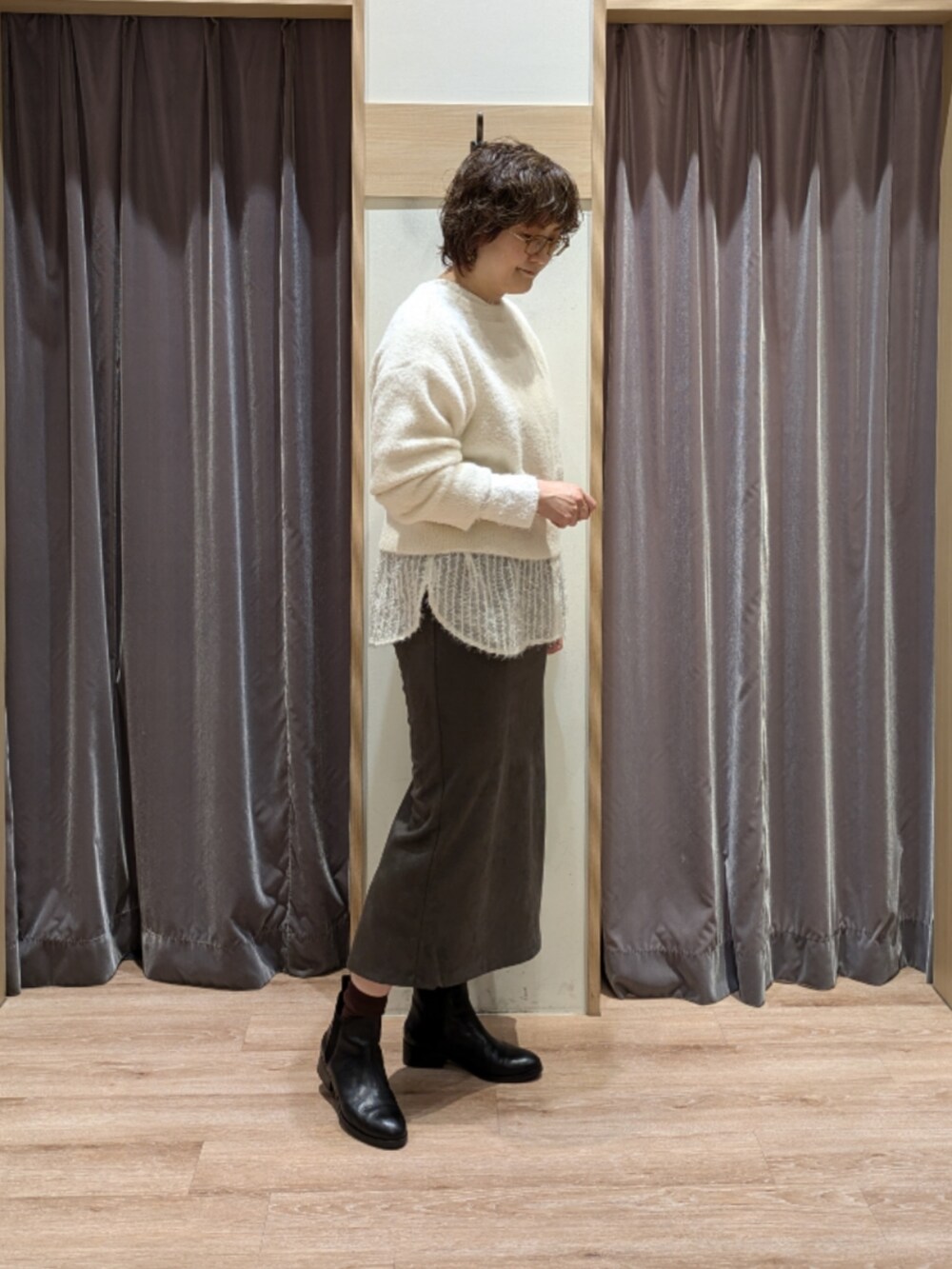 ブラック系のハンドバッグ、ホワイト系のカーディガン/ボレロ、ホワイト系のシャツ/ブラウスを着用したレディースの秋コーディネートの2枚目の写真