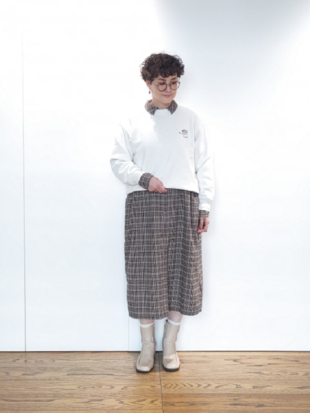 ベージュ系のハンドバッグ、ブラウン系のワンピース、グリーン系のその他アウターを着用したレディースの冬コーディネートの4枚目の写真