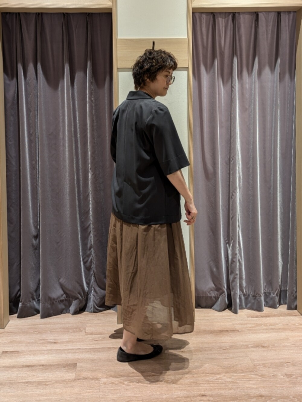 ホワイト系のハンドバッグ、グリーン系のワンピース、グレー系のノーカラージャケットを着用したレディースの夏コーディネートの3枚目の写真