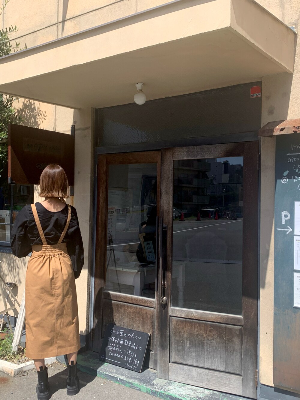 ブラック系のシャツ/ブラウス、ブラウン系のスカート、ブラック系のボストンバッグを着用したレディースの春コーディネートの2枚目の写真