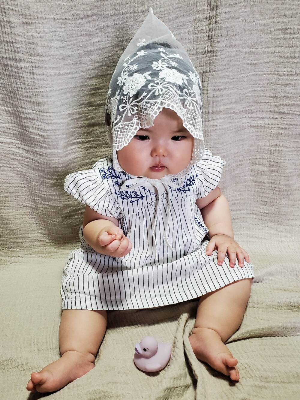 ホワイト系のワンピース、ホワイト系の帽子を着用したキッズの秋コーディネートの3枚目の写真