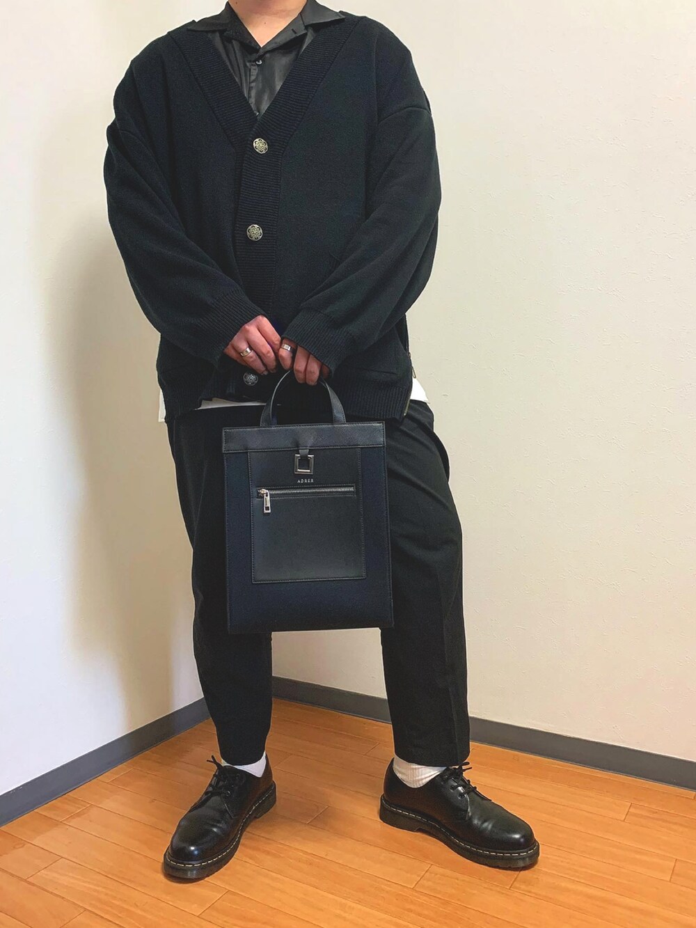 ブラック系のシャツ/ブラウス、ブラック系のトートバッグ、ブラック系のドレスシューズを着用したメンズの春コーディネートの2枚目の写真
