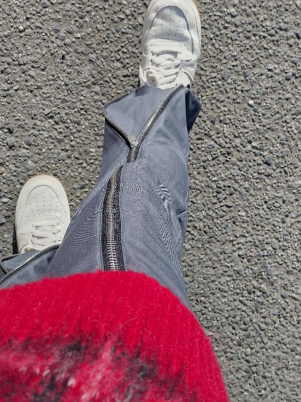 レッド系のニット/セーター、ホワイト系のデニムジャケット、グレー系のスラックスを着用したメンズの冬コーディネートの2枚目の写真