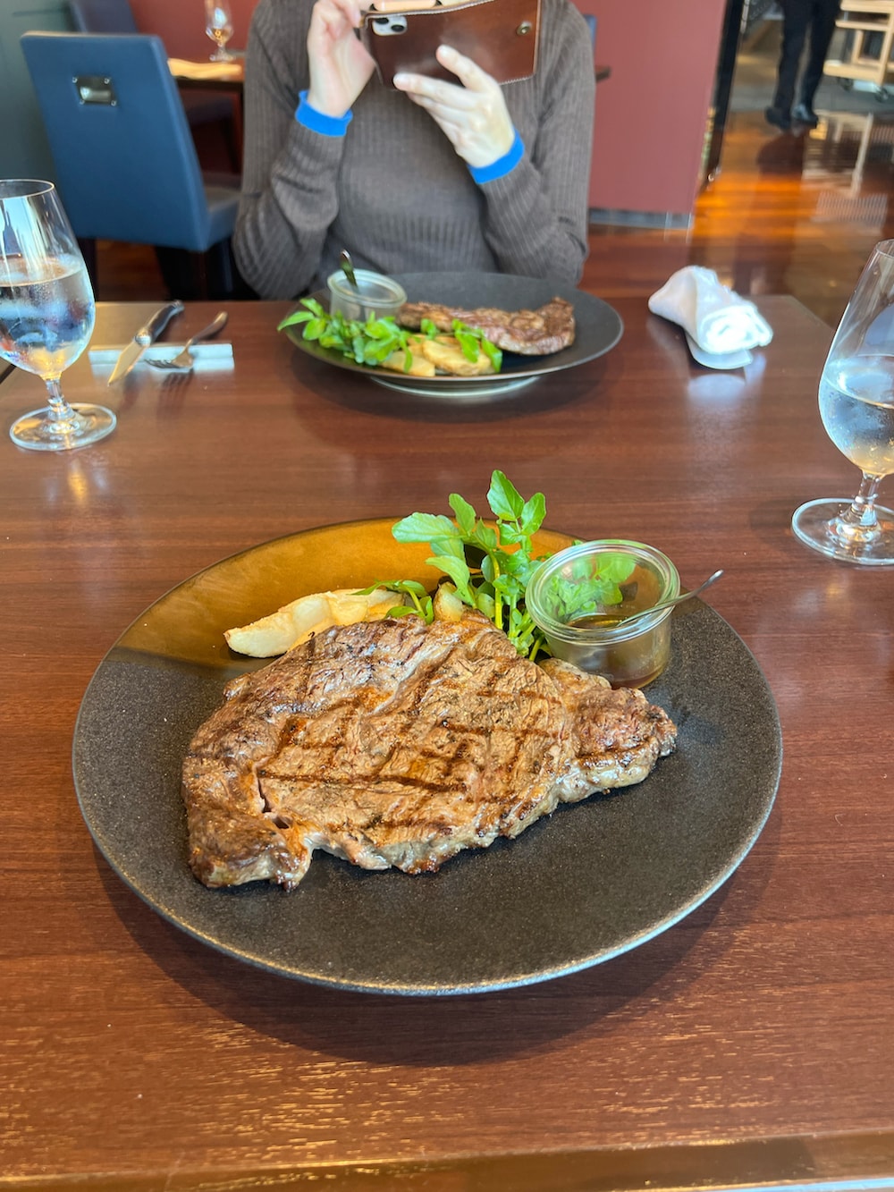 ブラック系のその他アウター、レッド系のスニーカーを着用したメンズの春コーディネートの2枚目の写真