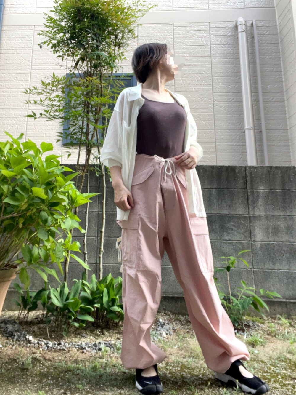 ピンク系のその他パンツ、ホワイト系のニット/セーター、ブラック系のサンダルを着用したレディースの夏コーディネートの2枚目の写真