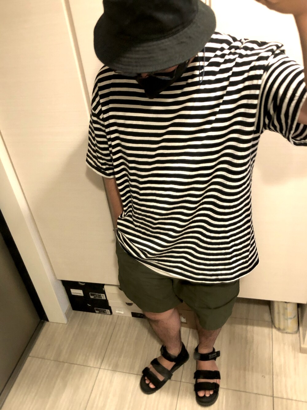 ブラック系のTシャツ/カットソー、グリーン系のその他パンツ、ブラック系のサンダルを着用したメンズの夏コーディネートの2枚目の写真