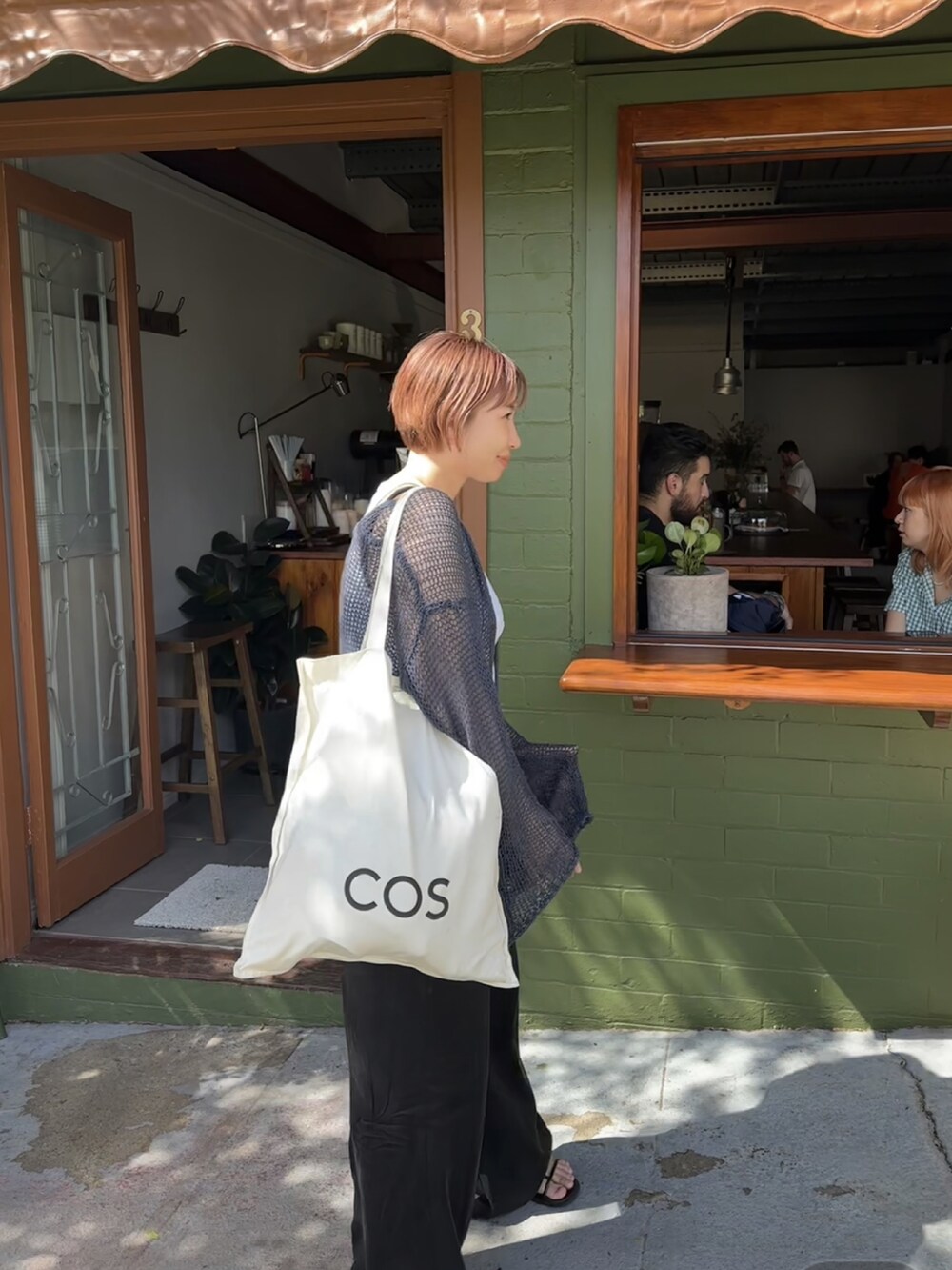 ブルー系のニット/セーター、ブラック系のその他パンツを着用したレディースの春コーディネートの3枚目の写真