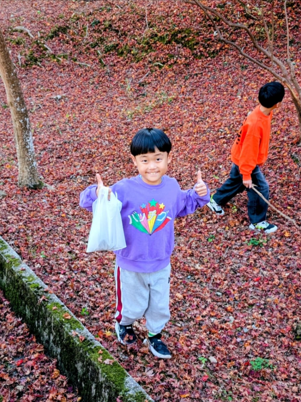 パープル系のスウェットを着用したキッズの秋コーディネートの2枚目の写真