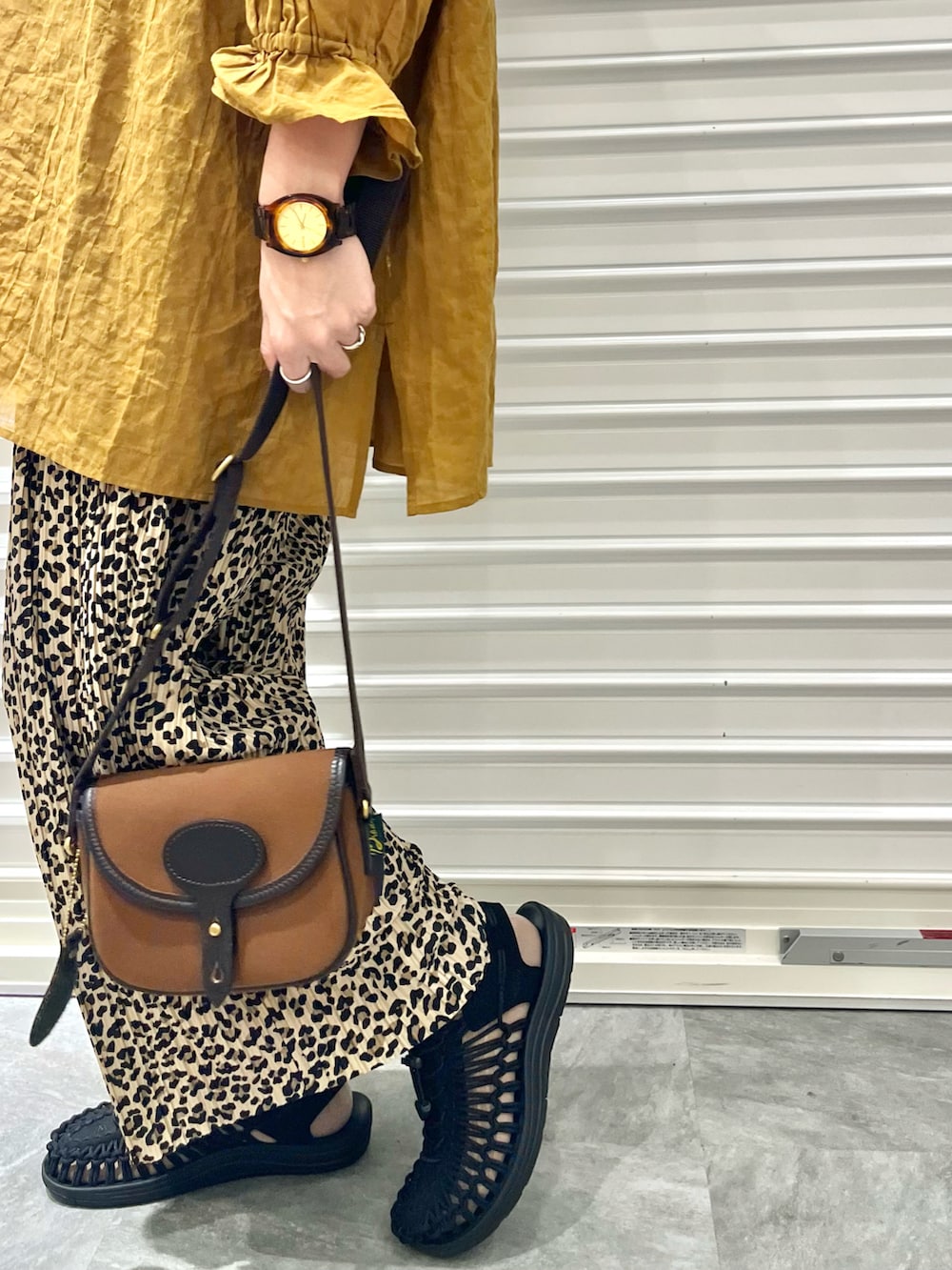 イエロー系のシャツ/ブラウス、ブラウン系のショルダーバッグ、ベージュ系のその他パンツを着用したレディースの秋コーディネートの2枚目の写真