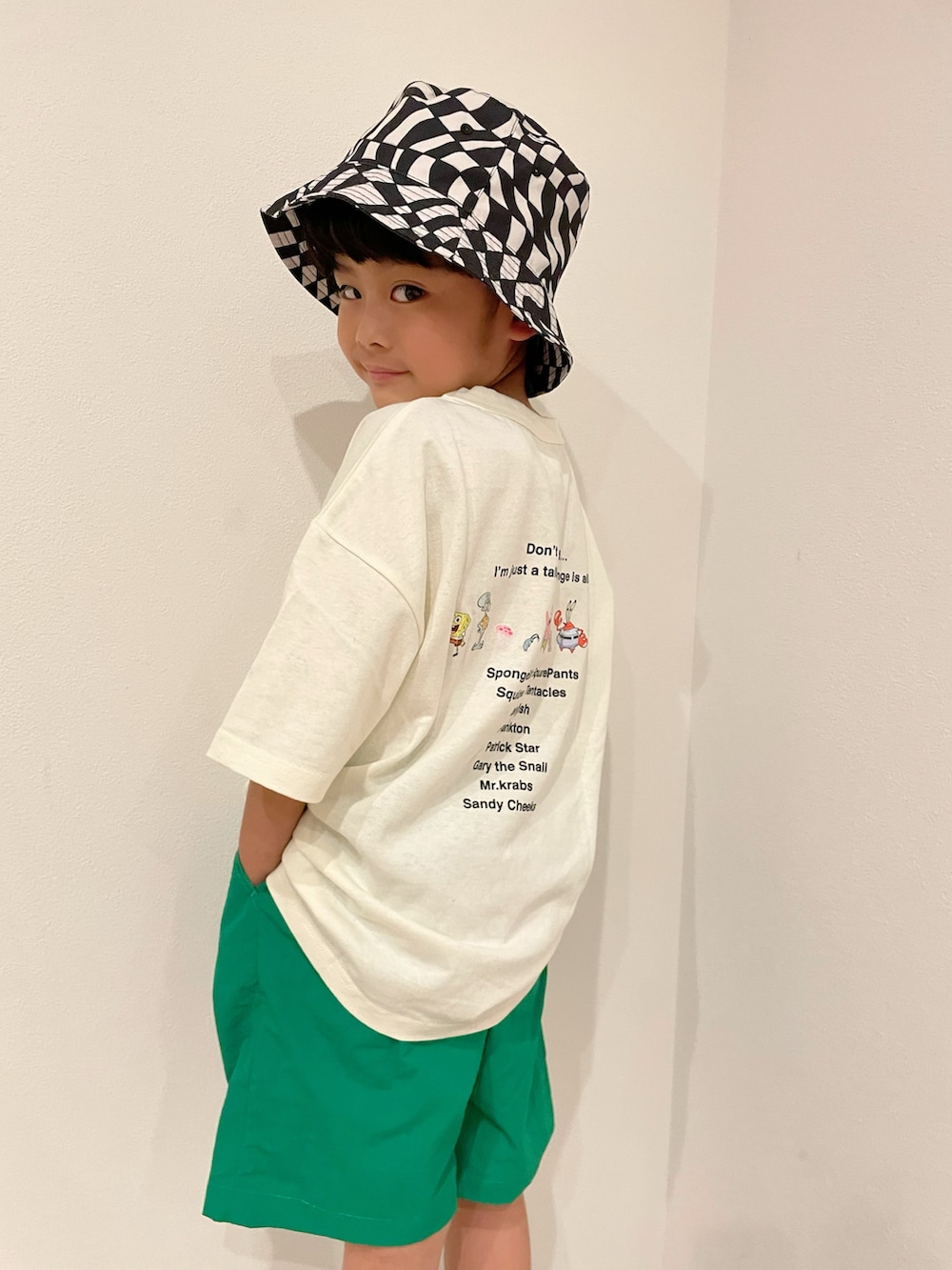 ブラック系のスニーカー、グリーン系のその他パンツ、ホワイト系のTシャツ/カットソーを着用したキッズの春コーディネートの2枚目の写真