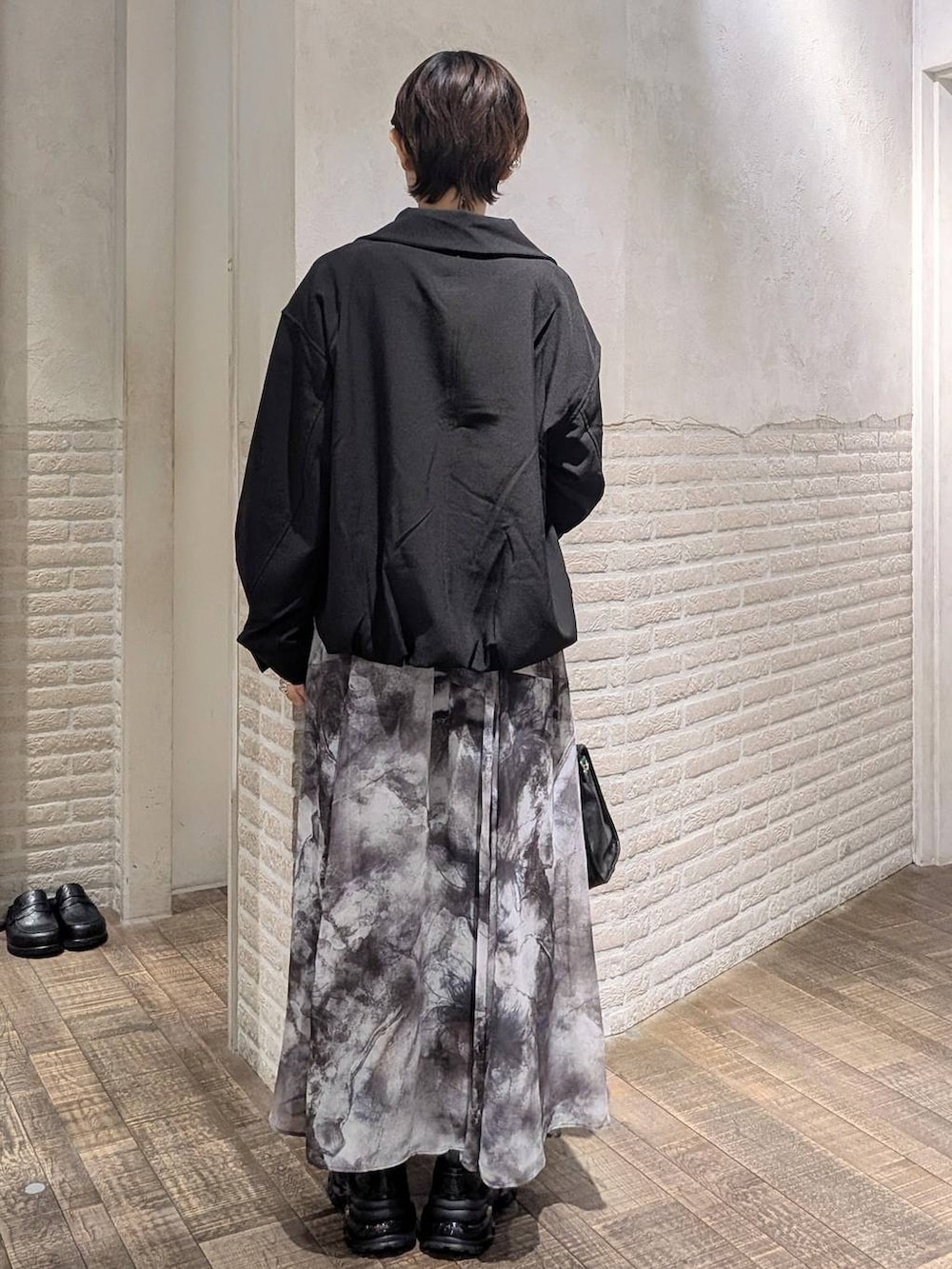 ブラック系のローファー、ブラック系のボストンバッグ、ブラック系のブルゾンを着用したレディースの春コーディネートの5枚目の写真