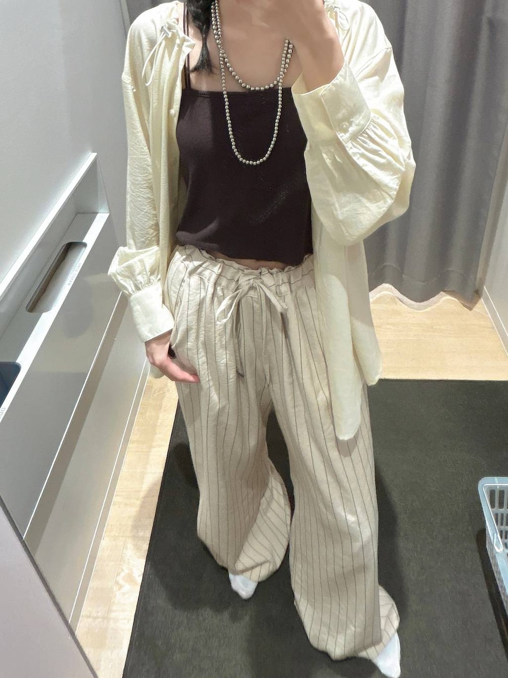 ブラック系のボストンバッグ、ホワイト系のその他パンツ、イエロー系のシャツ/ブラウスを着用したレディースの春コーディネートの5枚目の写真