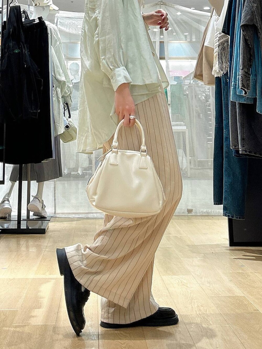 ホワイト系のショルダーバッグ、ホワイト系のその他パンツ、グリーン系のその他トップスを着用したレディースの春コーディネートの4枚目の写真