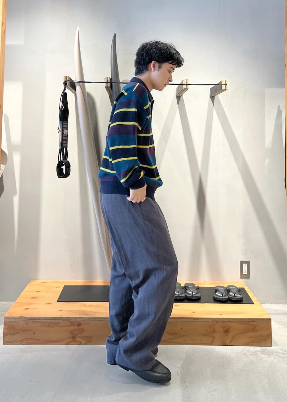 ブルー系のニット/セーター、グレー系のその他パンツを着用したメンズの秋コーディネートの3枚目の写真